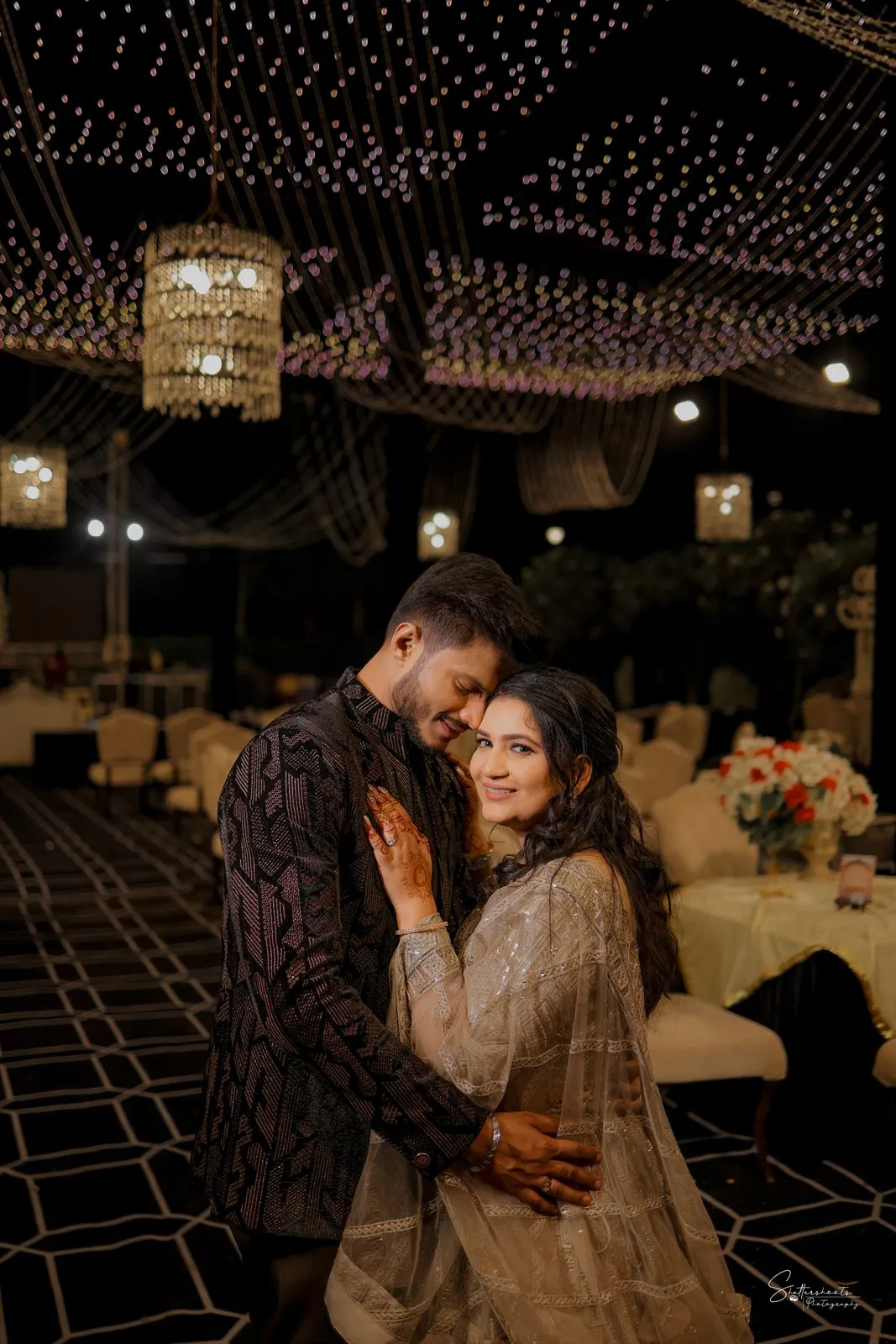 Couple at a fairy-lit reception