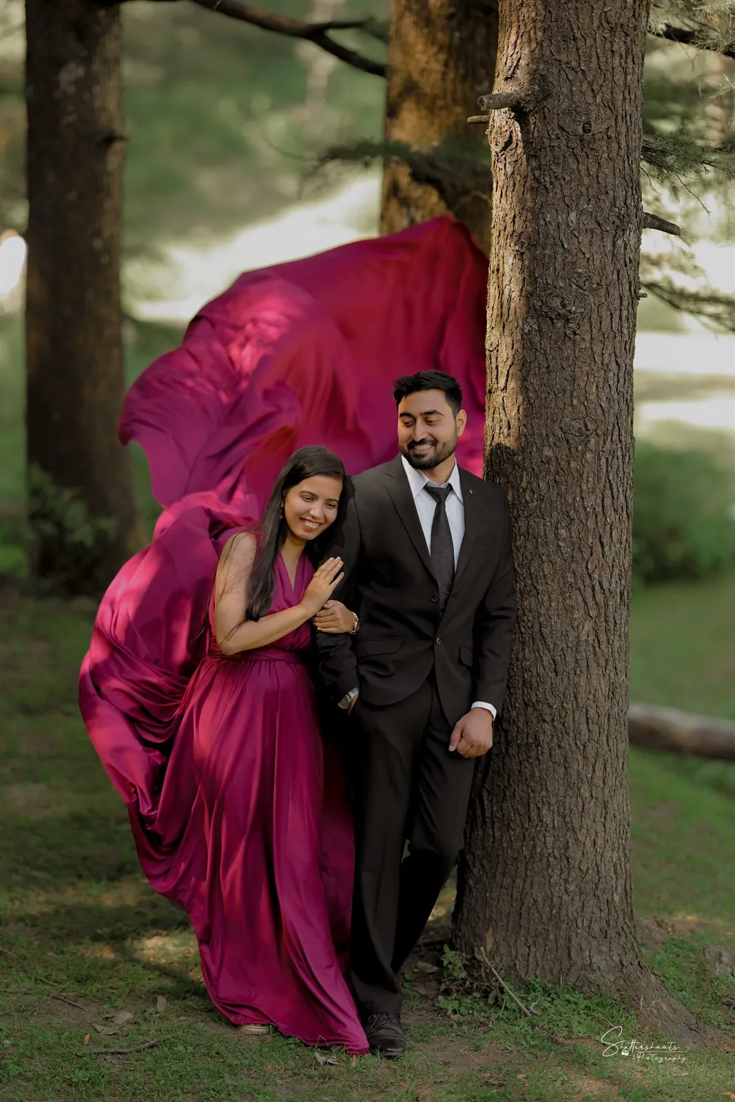 Couple by a tree with a flowing gown